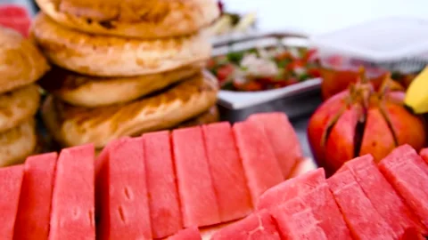 Bread and fruit on the picnic table outdoors in the park Stock Footage 254909323