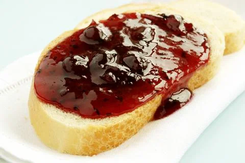 Bread and jam from the berries on a white napkin Stock Photos