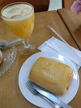 Bread and juice on the breakfast table. Stock Photos