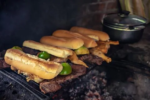 Bread and meat on meat roaster. Stock Photos