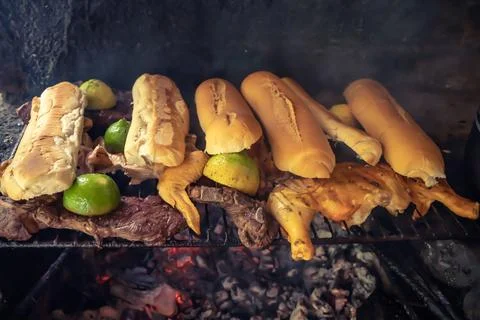 Bread and meat on meat roaster. Stock Photos