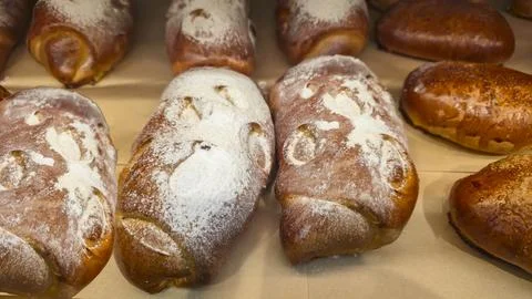 Bread and rolls on display at the store. Freshly baked goods for sale. Фото