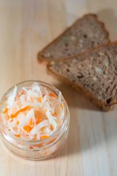 Bread and salted cabbage lie on a wooden board Stock Photos