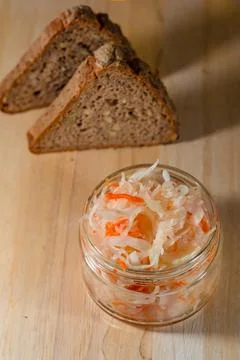 Bread and salted cabbage lie on a wooden board Stock Photos