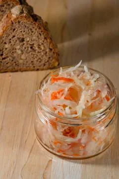 Bread and salted cabbage lie on a wooden board Stock Photos