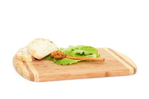 Bread and spoon with mustard Stock Photos