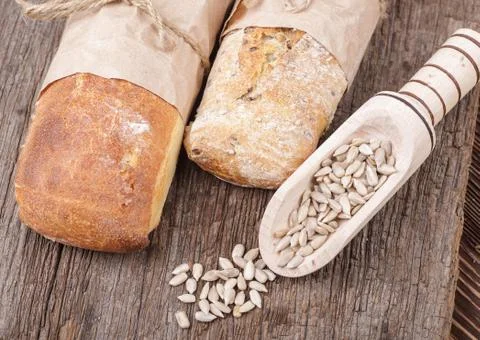 Bread and sunflower kernels Stock Photos