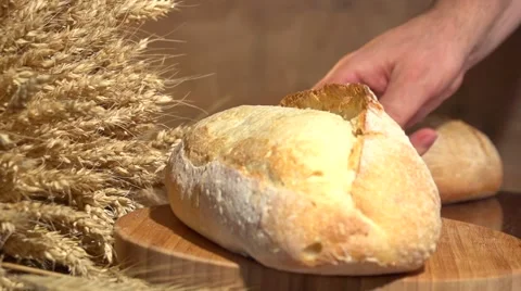 Bread and wheat ears on the table. Slow motion 240 fps. Video stock 54792182