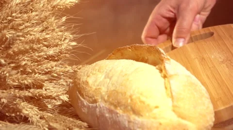 Bread and wheat ears on the table. Slow motion 240 fps. Video stock 55284053