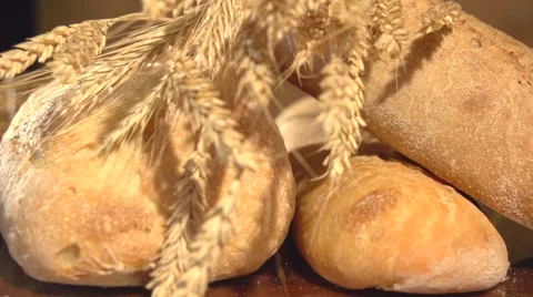 Bread and wheat ears on the table. Video stock 55903888