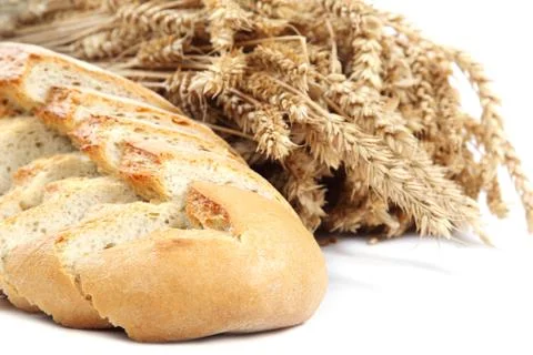 Bread and wheat ears on white background. Stock Photos