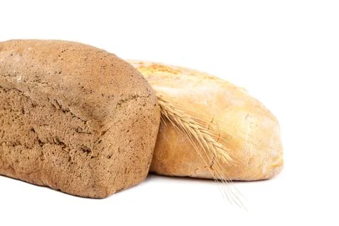 Bread and wheat ears on white background. Stock Photos