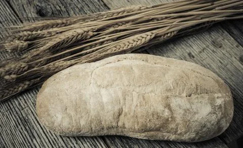 Bread and wheat on rustic wood background Stock Photos
