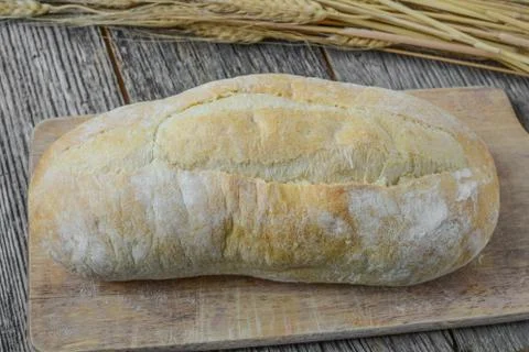 Bread and wheat on rustic wood background Foto stock