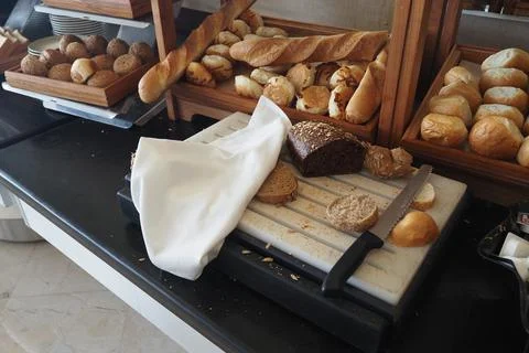 Bread is arranged on a table at a buffet setting Stock Photos