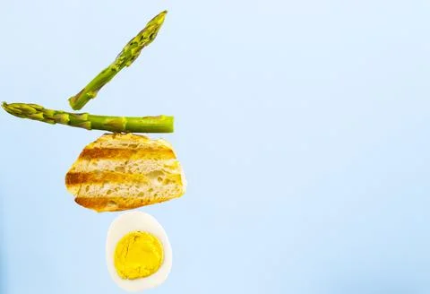 Bread, Asparagus and Egg. Ingridients for Breakfast. Equilibrium floating food Stock Photos
