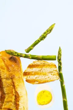 Bread, Asparagus and Egg. Ingridients for Breakfast. Equilibrium floating food Stock Photos