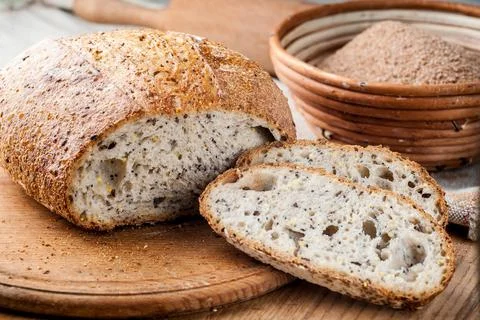 Bread. Baked bread. Craft bakery. Sliced bread on a wooden background. Food b Stock Photos