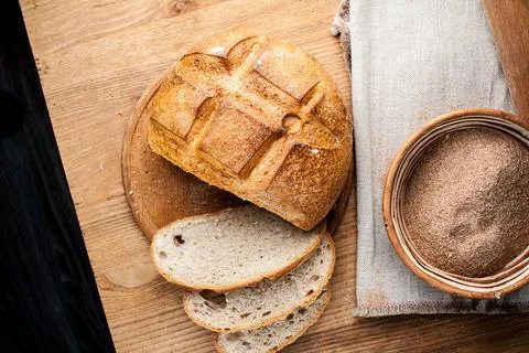 Bread. Baked bread. Craft bakery. Sliced bread on a wooden background. Food b Stock Photos