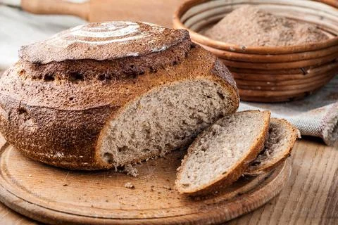 Bread. Baked bread. Craft bakery. Sliced bread on a wooden background. Food b Stock Photos