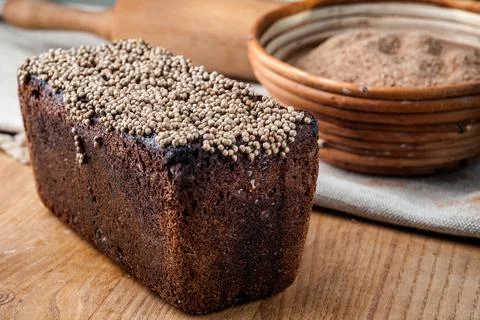 Bread. Baked bread. Craft bakery. Sliced bread on a wooden background. Food b Stock Photos