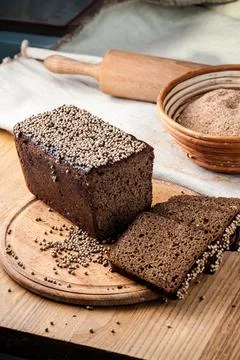 Bread. Baked bread. Craft bakery. Sliced bread on a wooden background. Food b Stock Photos
