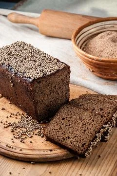 Bread. Baked bread. Craft bakery. Sliced bread on a wooden background. Food b Stock Photos