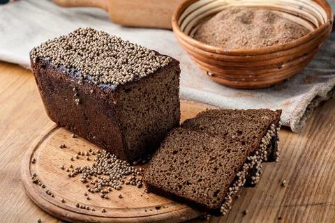 Bread. Baked bread. Craft bakery. Sliced bread on a wooden background. Food b Stock Photos