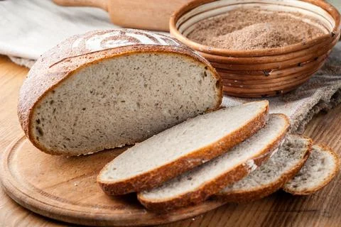 Bread. Baked bread. Craft bakery. Sliced bread on a wooden background. Food b Stock Photos