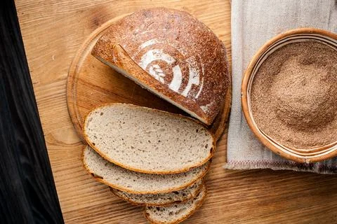 Bread. Baked bread. Craft bakery. Sliced bread on a wooden background. Food b Stock Photos