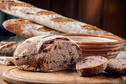 Bread. Baked bread. Craft bakery. Sliced bread on a wooden background. Food b Stock Photos