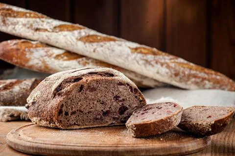 Bread. Baked bread. Craft bakery. Sliced bread on a wooden background. Food b Stock Photos