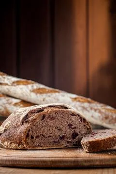 Bread. Baked bread. Craft bakery. Sliced bread on a wooden background. Food b Stock Photos