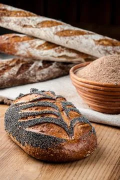 Bread. Baked bread. Craft bakery. Sliced bread on a wooden background. Food b Stock Photos