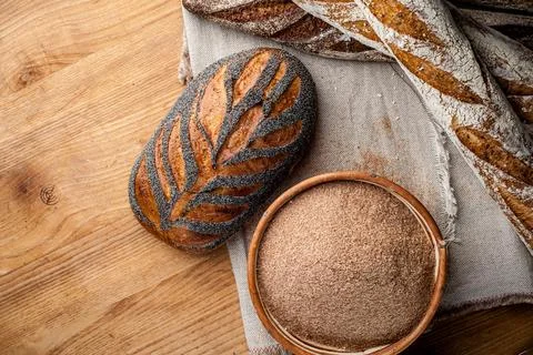 Bread. Baked bread. Craft bakery. Sliced bread on a wooden background. Food b Stock Photos