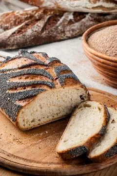 Bread. Baked bread. Craft bakery. Sliced bread on a wooden background. Food b Stock Photos