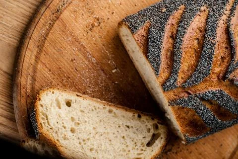 Bread. Baked bread. Craft bakery. Sliced bread on a wooden background. Food b Stock Photos