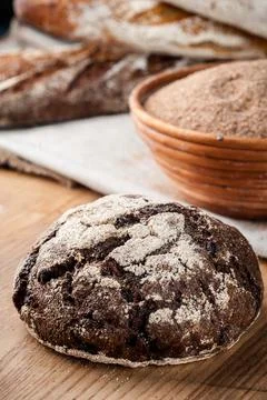 Bread. Baked bread. Craft bakery. Sliced bread on a wooden background. Food b Stock Photos