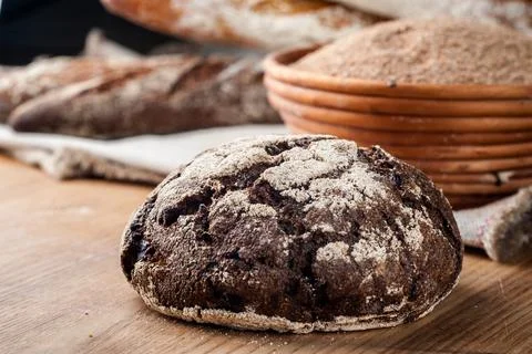 Bread. Baked bread. Craft bakery. Sliced bread on a wooden background. Food b Stock Photos