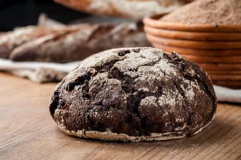 Bread. Baked bread. Craft bakery. Sliced bread on a wooden background. Food b Stock Photos