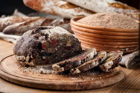 Bread. Baked bread. Craft bakery. Sliced bread on a wooden background. Food b Stock Photos