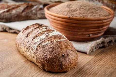 Bread. Baked bread. Craft bakery. Sliced bread on a wooden background. Food b Stock Photos