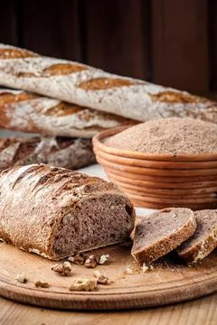 Bread. Baked bread. Craft bakery. Sliced bread on a wooden background. Food b Stock Photos