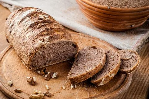 Bread. Baked bread. Craft bakery. Sliced bread on a wooden background. Food b Stock Photos