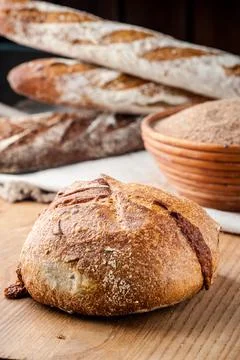Bread. Baked bread. Craft bakery. Sliced bread on a wooden background. Food b Stock Photos