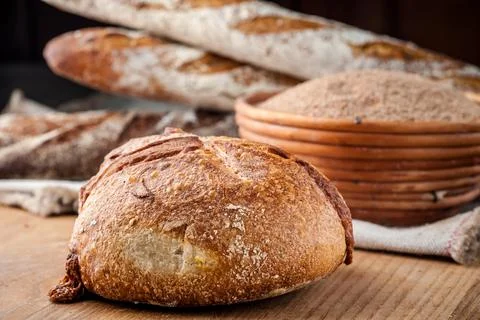 Bread. Baked bread. Craft bakery. Sliced bread on a wooden background. Food b Stock Photos