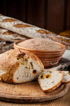 Bread. Baked bread. Craft bakery. Sliced bread on a wooden background. Food b Stock Photos
