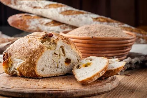 Bread. Baked bread. Craft bakery. Sliced bread on a wooden background. Food b Stock Photos
