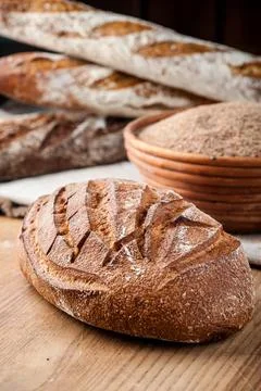 Bread. Baked bread. Craft bakery. Sliced bread on a wooden background. Food b Stock Photos
