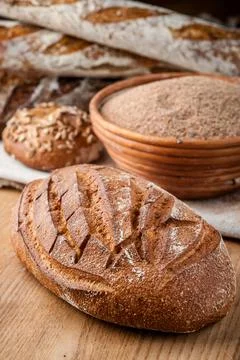 Bread. Baked bread. Craft bakery. Sliced bread on a wooden background. Food b Stock Photos